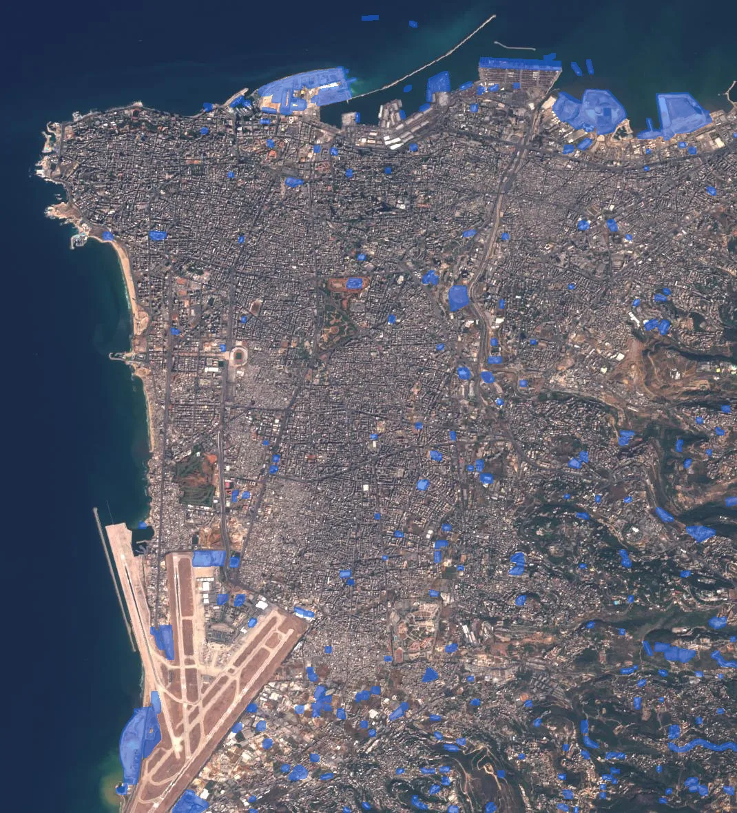 Two-date Sentinel-2 city scene with detected changes highlighted in blue